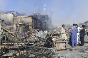 Afghans inspect damaged shops after fighting between Taliban and Afghan security forces in Kunduz city, northern Afghanistan, Sunday, Aug. 8, 2021. (AP Photo/Abdullah Sahil)
