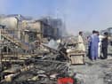 Afghans inspect damaged shops after fighting between Taliban and Afghan security forces in Kunduz city, northern Afghanistan, Sunday, Aug. 8, 2021. (AP Photo/Abdullah Sahil)