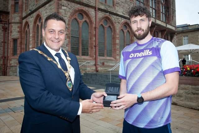 The Mayor of Derry City and Strabane District Council, Graham Warke pictured outside the Guildhall on Monday afternoon, making a special presentation to Danny Quigley who will shortly be taking part in an Iron Man Challenge to raise money for charity.  (Photo: Jim McCafferty Photography)