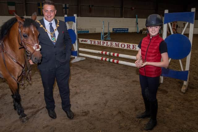 Derry City and Strabane District Council Mayor, Alderman Graham Warke who visited eleven years old Abbie-Rose McGeady at Templemore Stables to congratulate her achievement in reaching the 128 class in the forthcoming Dublin Horse Show where she will compete later this month. Abbie-Rose and the Mayor are pictured with her pony, Mirdads Baby Sitter. Picture Martin McKeown. 04.08.21