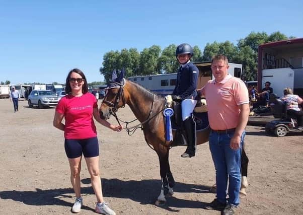 Sarah McLaughlin, who will compete in the National Championships this weekend, pictured with her parents, who own Malin Stables.