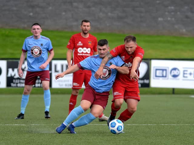 Institutes captain Cormac Burke, who was forced off by injury at half-time, holds off Annagh United’s Ryan Harpur. Photo: George Sweeney.