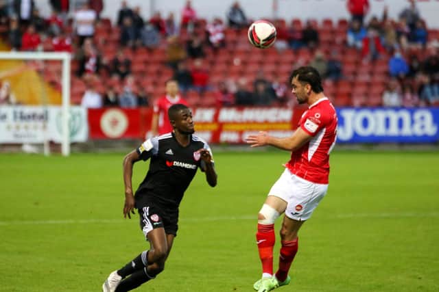 Sligo Rovers' John Mahon coolly heads the ball away from Derry City striker Junior Ogedi-Uzokwe. Picture by Kevin Moore/MCI