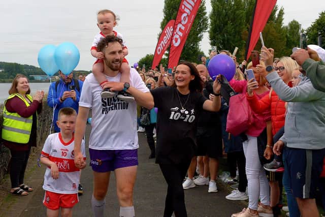 Danny Quigley’s partner Emear and sons Jack and Malachi accompany his on his arrival at Destined after completing a gruelling 10 Ironman Triathlons in 10 days in memory of his dad and fundraising over £68,000 for charities.  Photo: George Sweeney / Derry Journal.  DER2135GS – 020