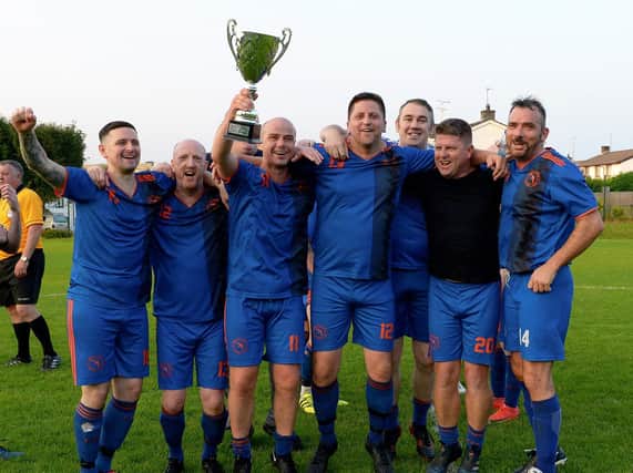 Telstar celebrate their victory over Foyle Harps in the Over 40s D&D Centenary Summer Cup final played at Magee on Friday evening last. Photo: George Sweeney. DER2134GS – 040