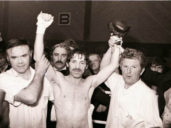 The late Tommy Donnelly (left) holds Charlie Nash's arm aloft after his European lightweight title victory in 1979. Trainer John Daly (right) is also pictured.