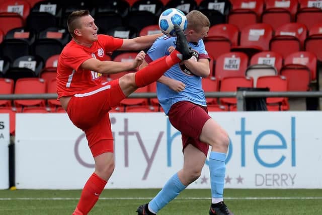 Dundela centre-back Jay McGee challenges Institute striker Aaron McGurk during Saturday’s game at Brandywell Stadium. Picture by George Sweeney.