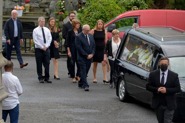 Members of Mr ODochartaighs family follow his hearse as it arrives at St Eugenes Cathedral for Requiem Mass.