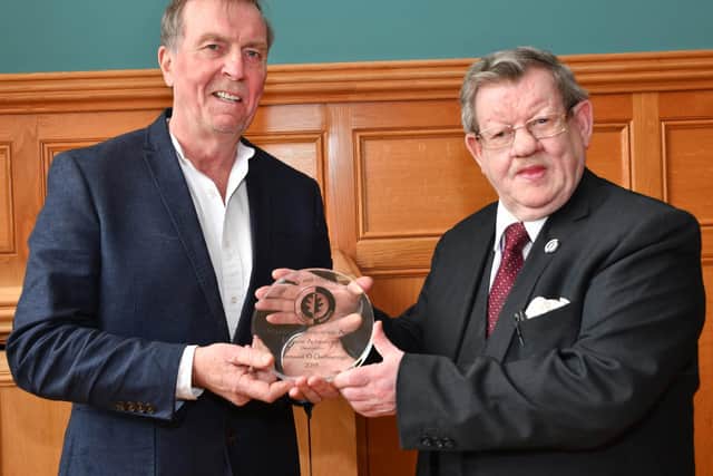2019... Aidan McKinney presents Fionnbarra O'Dochartaigh with a lifetime achievement award in recognition of his contribution to civil rights issues.