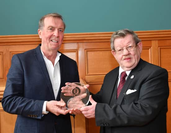 2019... Aidan McKinney presents Fionnbarra O'Dochartaigh with a lifetime achievement award in recognition of his contribution to civil rights issues.