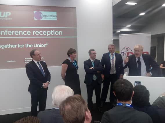 Jeffrey Donaldson, with party colleagues, listening to Boris Johnson at a DUP drinks reception at the Conservative Party conference in October 2019.