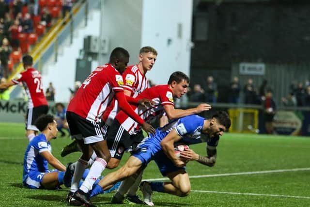 Joe Thomson is among the Derry City players attempting to retrieve the ball in the dying moments of Friday's feisty derby clash with Finn Harps. Photo by Kevin Moore.