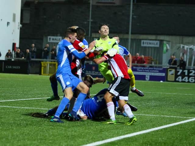 Harps keeper Mark Anthony McGinley gets involved in the fracas after Thomson's equalising goal.