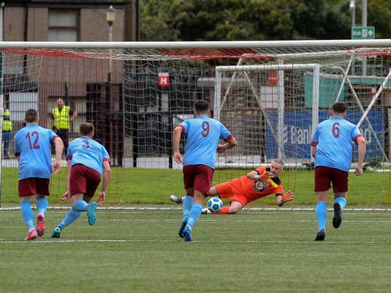 Institute goalkeeper saves Michael McLennen's retaken penalty kick for the second time. Photo: George Sweeney