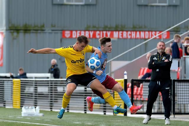Institute's Jamie Dunne and H&W Welders’ Matthew Henry battle for possession at Brandywell on Saturday afternoon last.  Photo: George Sweeney. DER2136GS – 104