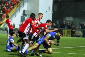 Derry City players attempt to retrieve the ball in the dying seconds of the north west derby after Joe Thomson levelled the game. Photographs by Kevin Moore.