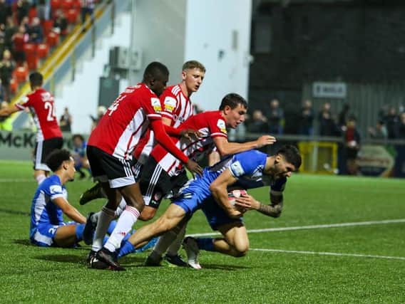 Derry City players attempt to retrieve the ball in the dying seconds of the north west derby after Joe Thomson levelled the game. Photographs by Kevin Moore.