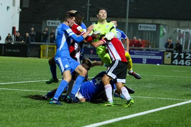 Finn Harps keeper Mark Anthony McGinley and Derry City midfielder Joe Thomson collide at the end of the derby. Both players received three match bans for their actions.