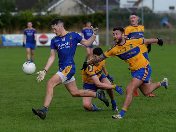 Steelstown’s Oran McMenamin evades a challenge from Wolfhounds’ Ben Deery and Aaron McGregor to score a first half point at Scroggy Road on Sunday. Photo: George Sweeney.