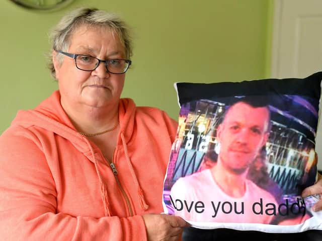 Ruth Bone holding a memento of her late son Dale.
