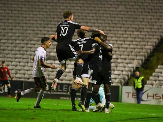 Derry City players race to celebrate with goalscorer Junior Ogedi-Uzokwe at Bohemians on Monday night. Photograph by Kevin Moore.