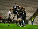 Derry City players race to celebrate with goalscorer Junior Ogedi-Uzokwe at Bohemians on Monday night. Photograph by Kevin Moore.