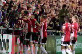 Derry City striker Junior Ogedi-Uzokwe celebrates with the home support and his teammates after netting the third goal against Longford. Photograph by Kevin Moore.