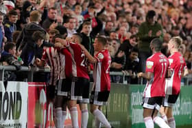 Derry City striker Junior Ogedi-Uzokwe celebrates with the home support and his teammates after netting the third goal against Longford. Photograph by Kevin Moore.