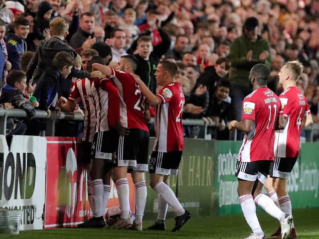 Derry City striker Junior Ogedi-Uzokwe celebrates with the home support and his teammates after netting the third goal against Longford. Photograph by Kevin Moore.