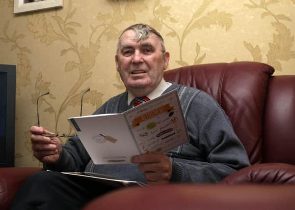 2015:  Derry City Councillor Jim Clifford reading some wellwisher cards at his Creggan home as he retired. DER1315MC057