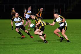 Doire Colmcille's Joe McCartie tugs at the jersey of  Ardmore's Jordon Barrow during Friday evening's game in Celtic Park. Photo: George Sweeney