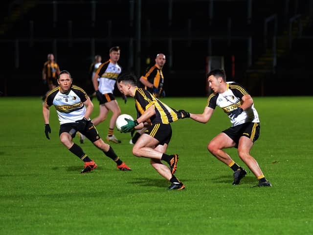 Doire Colmcille's Joe McCartie tugs at the jersey of  Ardmore's Jordon Barrow during Friday evening's game in Celtic Park. Photo: George Sweeney