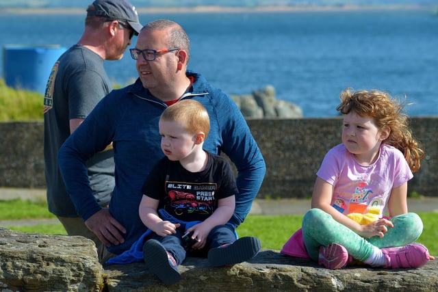 Spectators at the children’s Pedal Powered Tractor Run and Doll Push, at the Greencastle Regatta, on Friday afternoon last. Photo: George Sweeney.  DER2231GS – 080