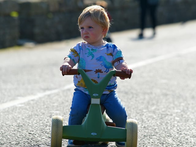 Keeping an eye on the competition during the Pedal Powered Tractor Run and Doll Push race at the Greencastle Regatta on Friday afternoon last. Photo: George Sweeney. DER2231GS – 079