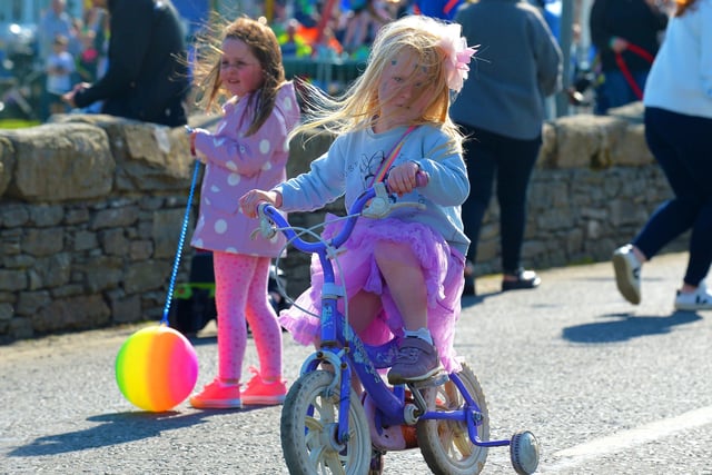 A young girl makes her way to the finish line in the Pedal Powered Tractor Run and Doll Push race at the Greencastle Regatta on Friday afternoon last. Photo: George Sweeney.  DER2231GS – 077