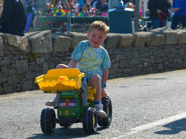This young man is determined to finish the Pedal Powered Tractor Run and Doll Push race held during the Greencastle Regatta on Friday afternoon last. Photo: George Sweeney. DER2231GS – 075