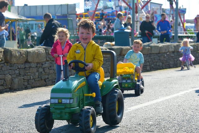 This young man is enjoying the Pedal Powered Tractor Run and Doll Push race held during the Greencastle Regatta on Friday afternoon last. Photo: George Sweeney.  DER2231GS – 074