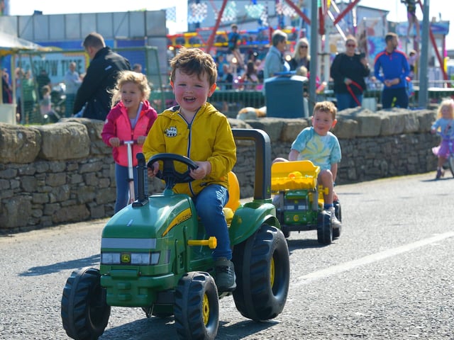 This young man is enjoying the Pedal Powered Tractor Run and Doll Push race held during the Greencastle Regatta on Friday afternoon last. Photo: George Sweeney.  DER2231GS – 074
