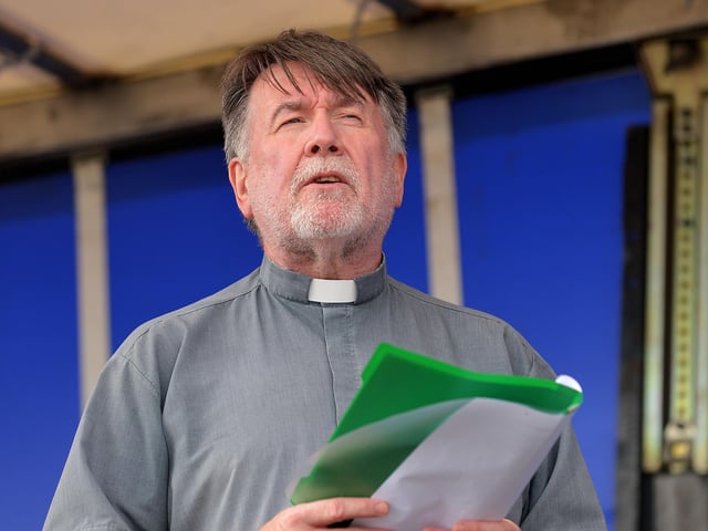 Fr Patrick O’Hagan PP, Moville, offers prayers at the Annual Blessing of the Greencastle fishing fleet on Friday afternoon last. Photo: George Sweeney. DER2231GS – 063