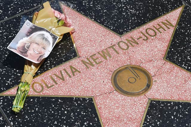 HOLLYWOOD, CALIFORNIA - AUGUST 08: Flowers are placed on Olivia Newton-John's Hollywood Walk of Fame star on August 08, 2022 in Hollywood, California. (Photo by Rodin Eckenroth/Getty Images)