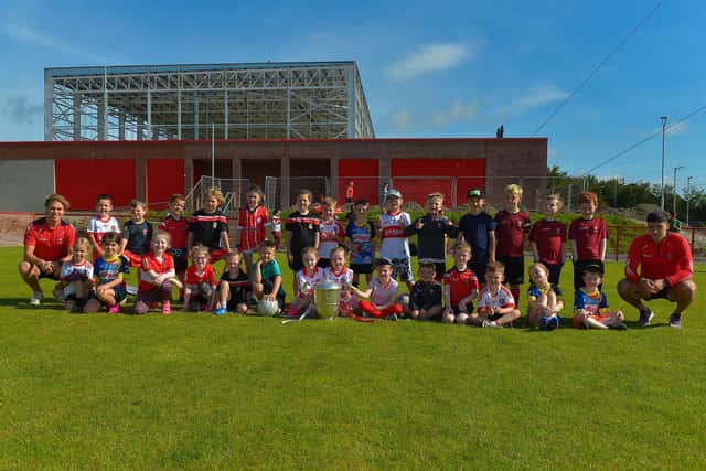 Some of the Boys and girls who took part in the Sean Dolan’s Cul Camp held on Tuesday last pictured with the Anglo Celt Cup and County players Donncha Gilmore and Ben McCarron . Photo: George Sweeney.  DER2232GS – 002