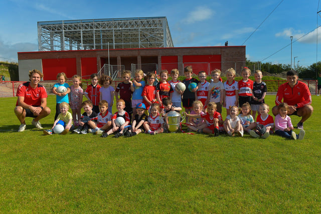 Some of the children who took part in the Sean Dolan’s Cul Camp held on Tuesday last pictured with the Anglo Celt Cup and County players Donncha Gilmore and Ben McCarron . Photo: George Sweeney.  DER2232GS – 003