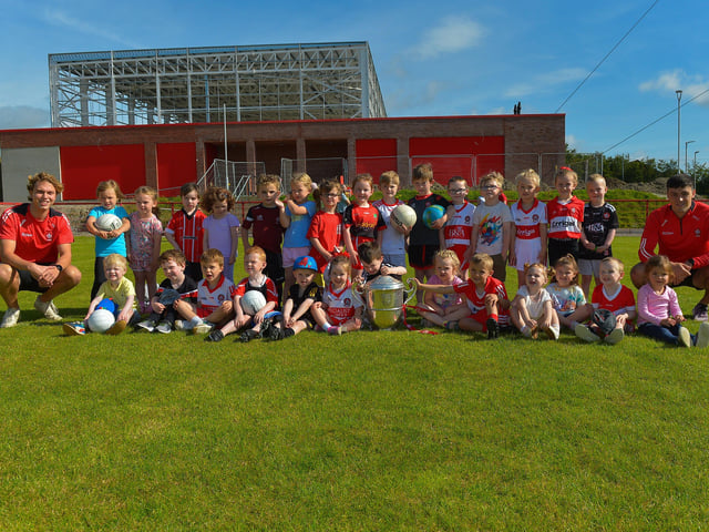 Some of the children who took part in the Sean Dolan’s Cul Camp held on Tuesday last pictured with the Anglo Celt Cup and County players Donncha Gilmore and Ben McCarron . Photo: George Sweeney. DER2232GS – 003