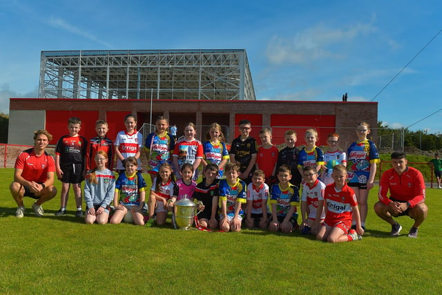 Children who took part in the Sean Dolan’s Cul Camp held on Tuesday last pictured with the Anglo Celt Cup and County players Donncha Gilmore and Ben McCarron . Photo: George Sweeney.  DER2232GS – 004