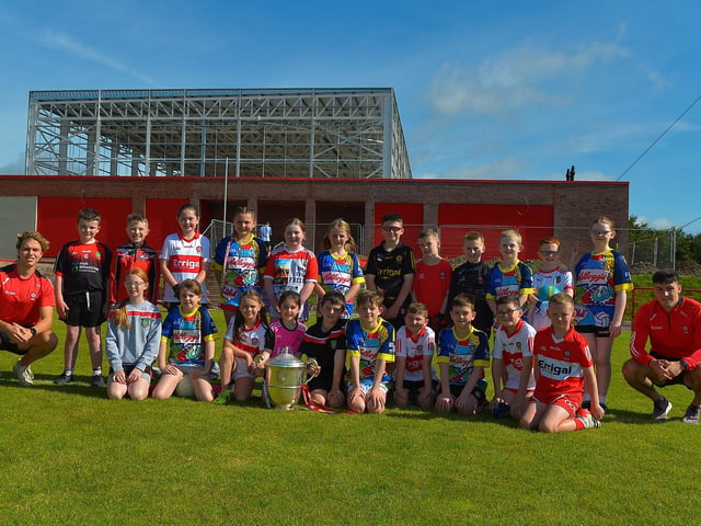 Children who took part in the Sean Dolan’s Cul Camp held on Tuesday last pictured with the Anglo Celt Cup and County players Donncha Gilmore and Ben McCarron . Photo: George Sweeney. DER2232GS – 004