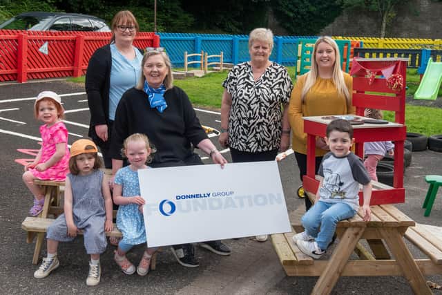 Roisin Donnelly, Nicola Costiff and Paula Scullion from the Donnelly Group Foundation who visited Pennyburn Community Playgroup and their manager Helen Brady to see the picnic benches, kitchen and bridge donated by the well known car dealership. Included are children,  Aria McCool, Franny Robbins, Maisie McLaughlin, Noah Shields. Picture Martin McKeown.