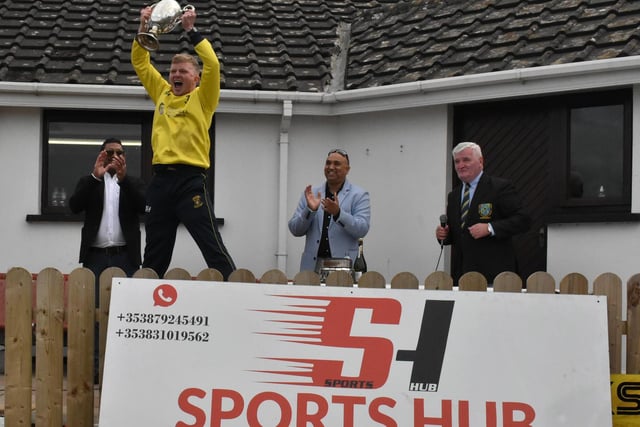 Fox Lodge captain Aaron Heywood almost clears the pavilion as he raises the club's first Sports Hub North West Senior Cup at Eglinton on Saturday. (Photo: Lawrence Moore)