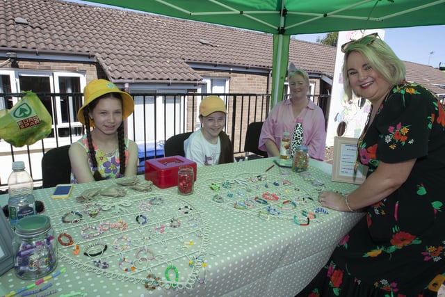 Mayor Sandra Duffy admiring some of the skilful work of these two young entrepreneurs at the Leafair Summer Fun Day on Thursday. Isla Harkin-McGilloway and Micha Phelan. Centre right is Micha's mum Michelle. (Photos: Jim McCafferty Photography)