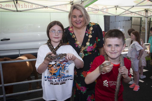 The Mayor Sandra Duffy pictured with Aodhan and Lara Hutton and their friendly snakes at the Leafair Summer Fun Day on Thursday.