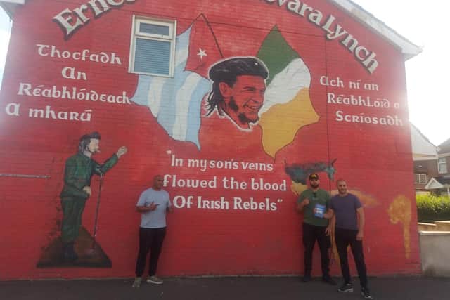 Mr. Dennis with friends at the Che Guevara mural in the Bogside.